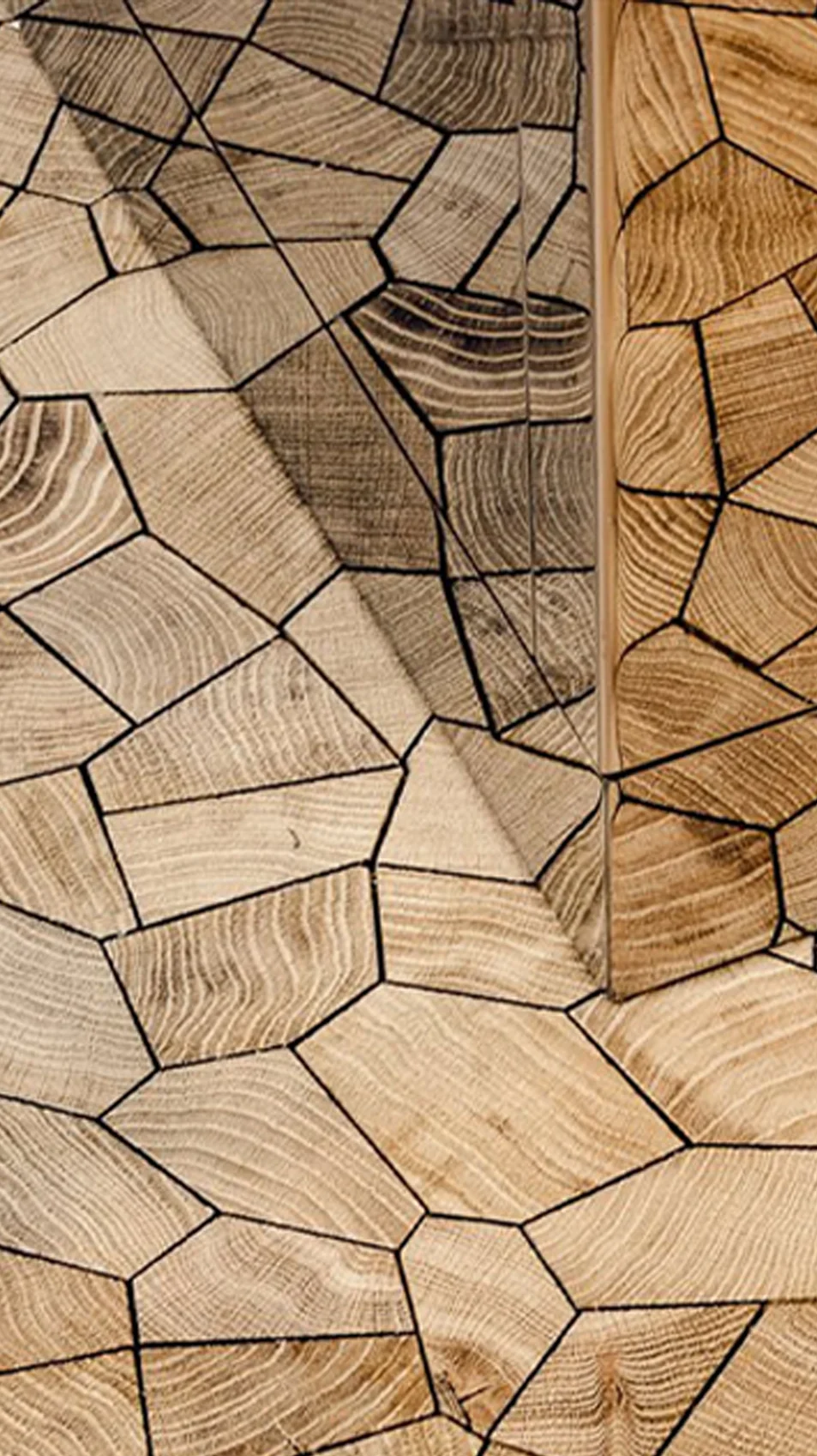 An Opus endgrain oak floor, its irregular blocks running up to a threshold